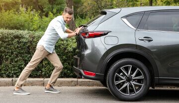 man pushing a lemon car